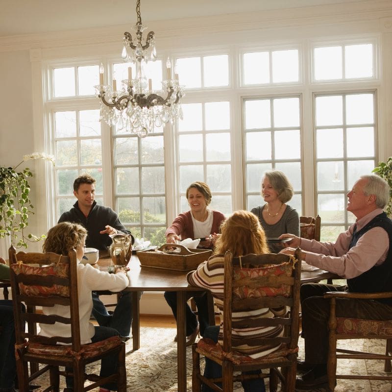 Family eating dinner in a large fancy dining room