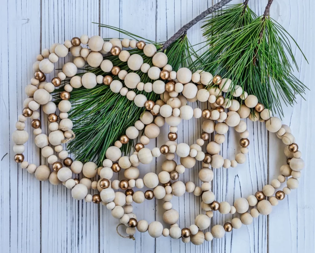 Boho Wood Bead Christmas Garland on a holly ranch on a white rustic wood background