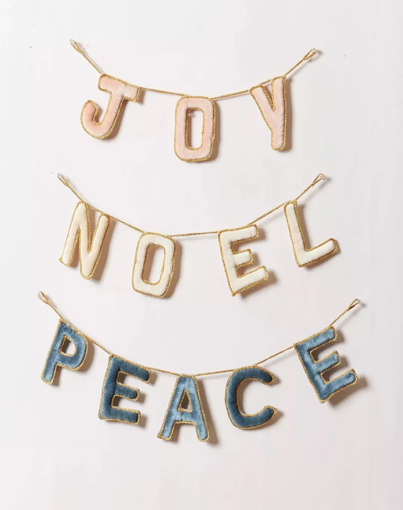 Farmhouse Pottery Holiday Greeting Garland from Anthropologie on a white background