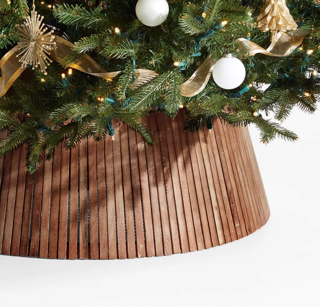 Skei Wood Natural Christmas Tree Collar on a Christmas tree on a white background