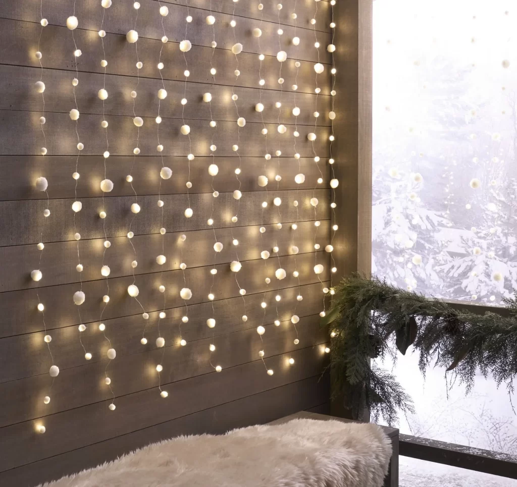 Snowball Rain String Lights from Pottery Barn on a wood wall