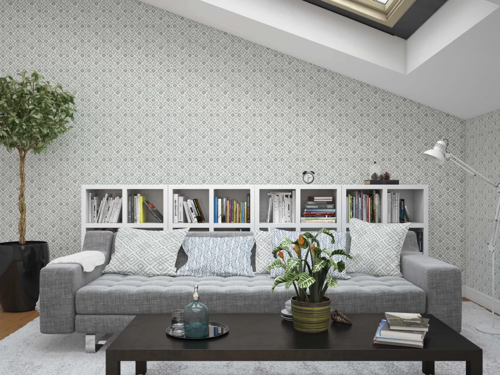 Color Caravan Oushak Wallpaper in Moss behind a grey sofa and white bookcase.
